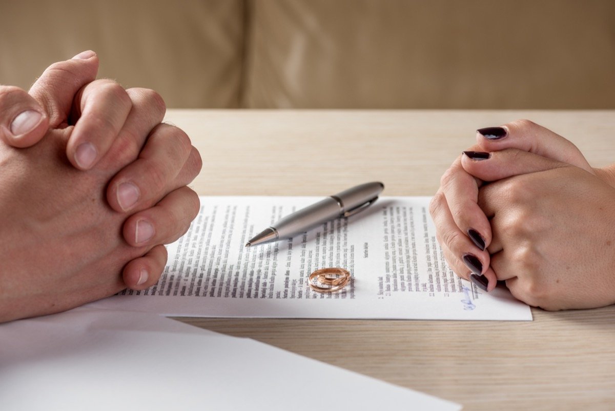 Man and woman signing divorce papers